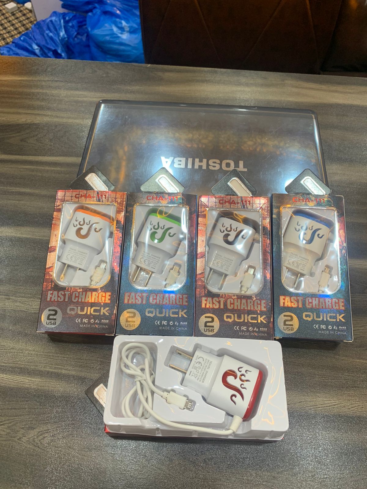 Packaged electronic chargers on a Toshiba branded surface