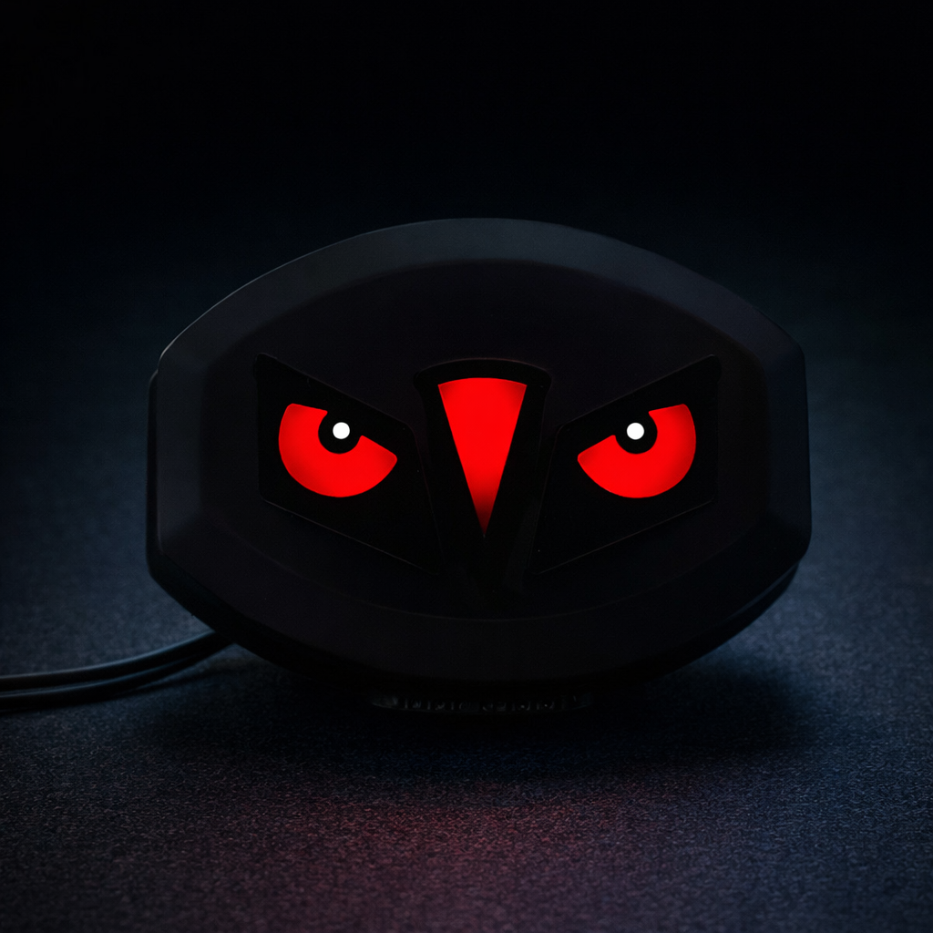 Black gaming mouse with red glowing eyes on a dark background