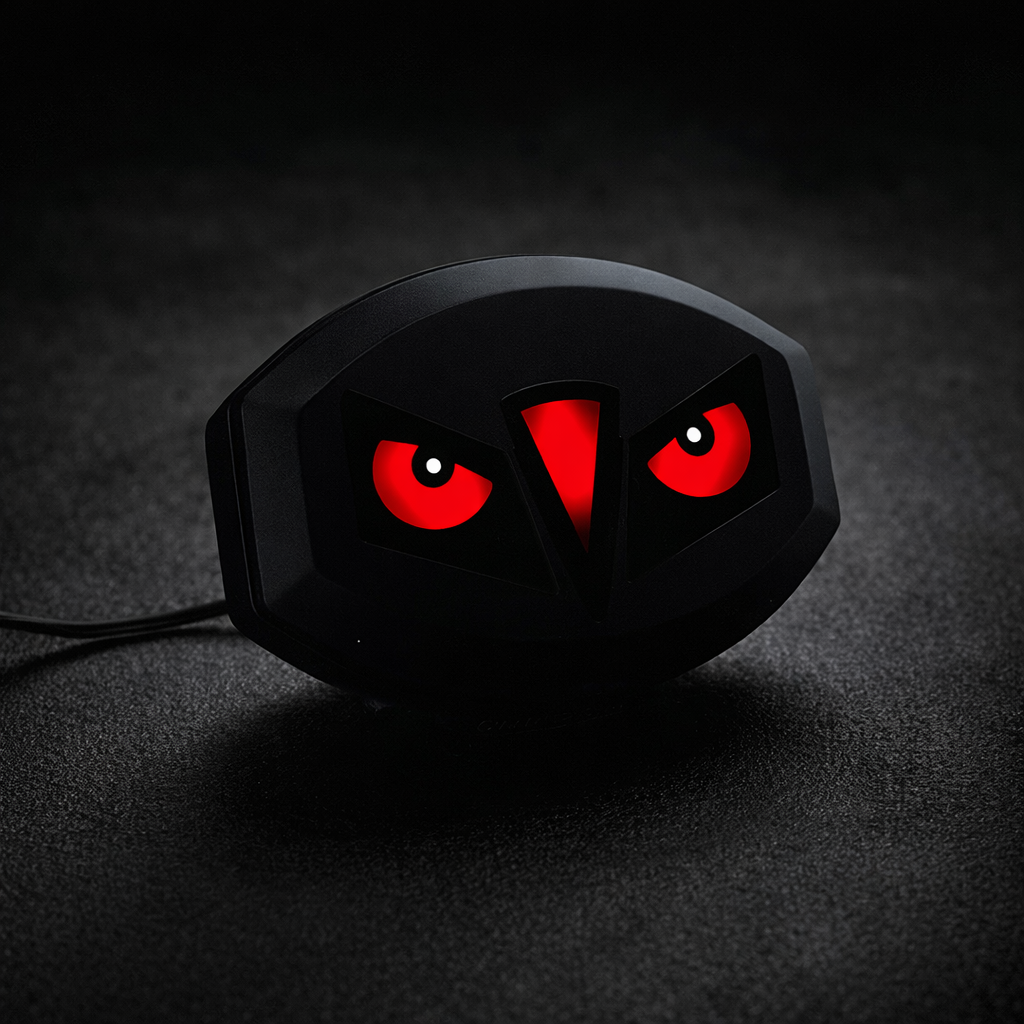 Black gaming headset with red LED eyes on a dark background